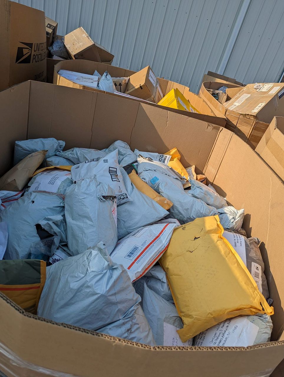 WhatsApp-Image-2026-03-29-at-1.19.08-AM.jpeg USPS unclaimed mail 8 foot pallet — 20-box tall pallet of USPS-specific first-class, Priority Mail, and Media Mail unclaimed parcel recovery