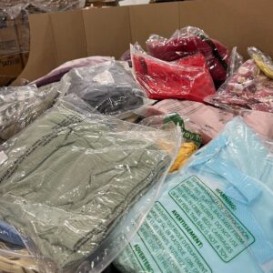 Amazon clothing pallet — 6 foot tall Amazon apparel load with mixed men's, women's, and kids clothing in green-stripe poly bags