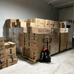 Amazon mystery box pallet — 20 sealed Amazon mystery boxes stacked on a wrapped pallet, mixed general merchandise from Amazon returns and overstock