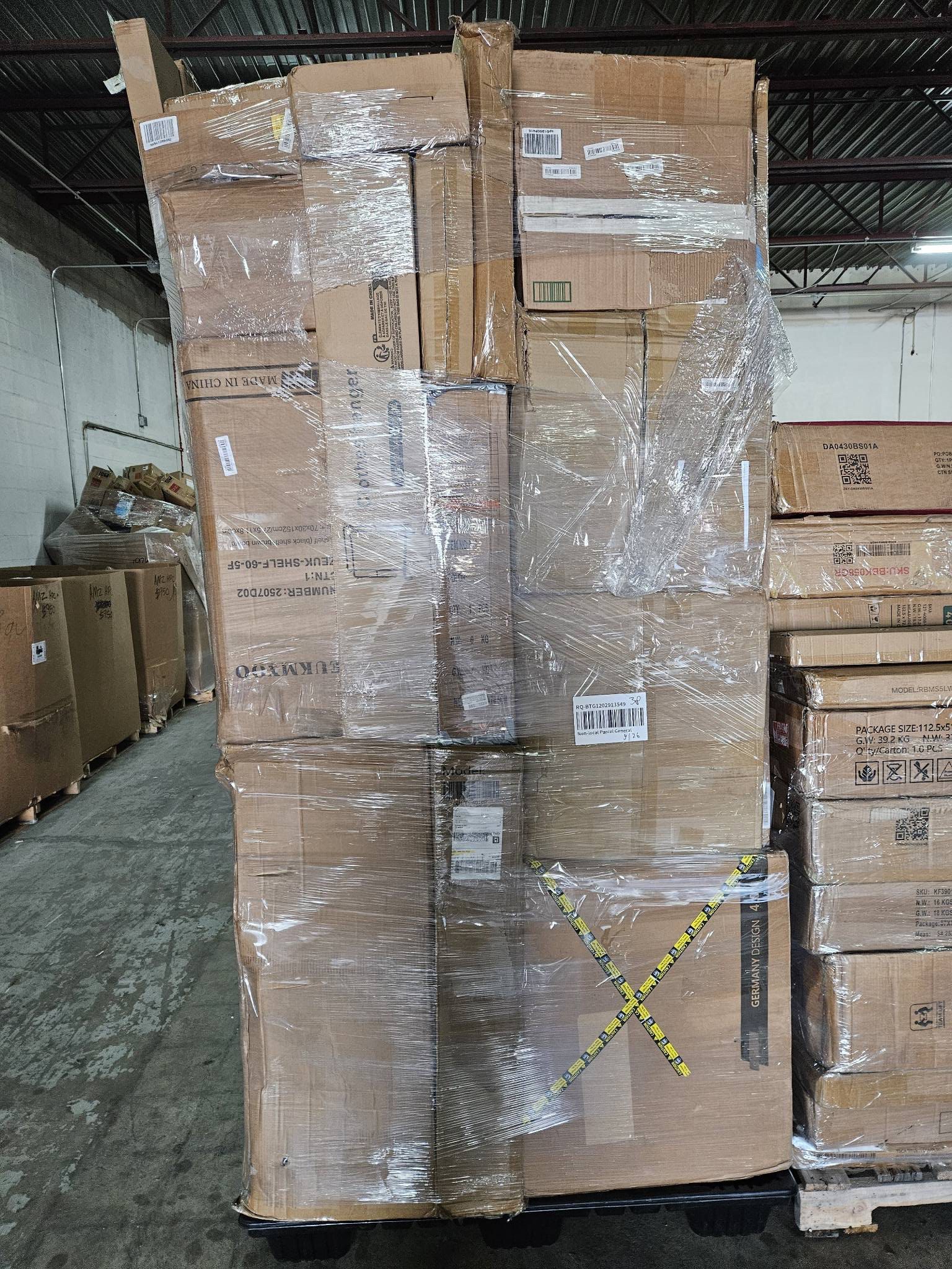 img_2375.jpeg Undeliverable stacked pallet — single stacked-format pallet of mixed carrier undeliverable parcels from USPS, UPS, FedEx, and Amazon for mystery-package resellers