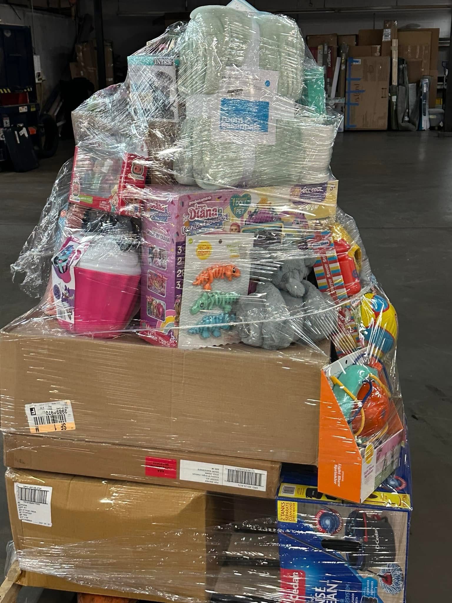 img_4202.jpeg Target toys liquidation pallet — stacked sealed cartons of mixed brand-name toys from Target store closeouts