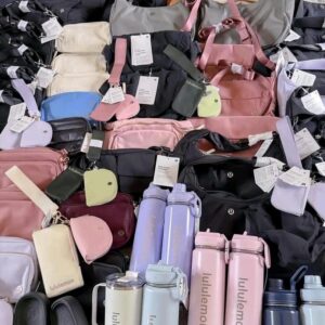 Lululemon makeup bag wholesale bundle — 75 authentic Lululemon cosmetic bags and 40+ Lululemon accessories stacked for shipping
