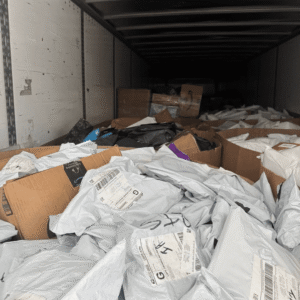 Premium undeliverable HPC pallet — single high-piece-count pallet of premium-tier undeliverable parcel recovery with UPS and FedEx residential weighting