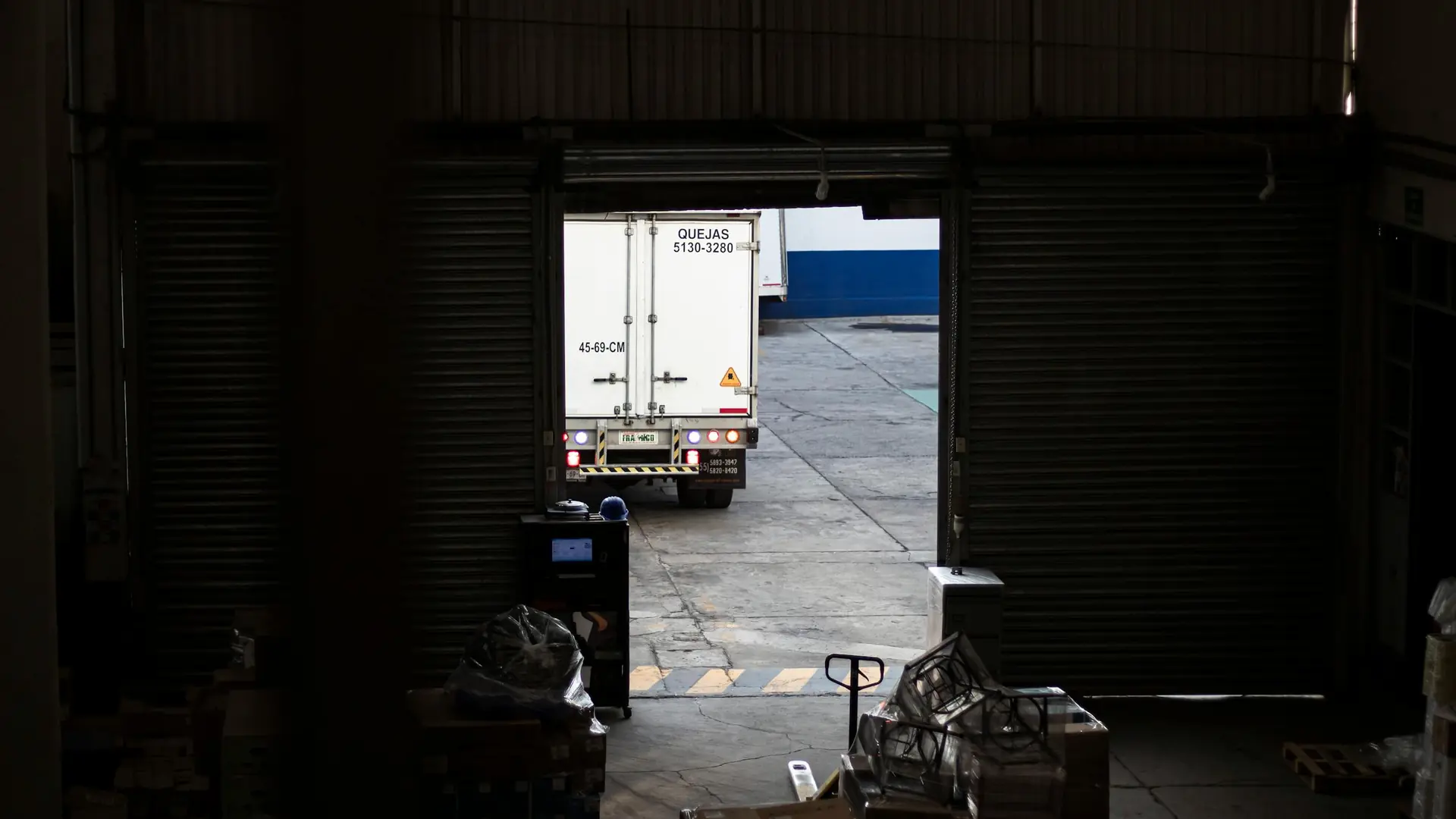 Delivery truck departing SaveMore warehouse loading dock